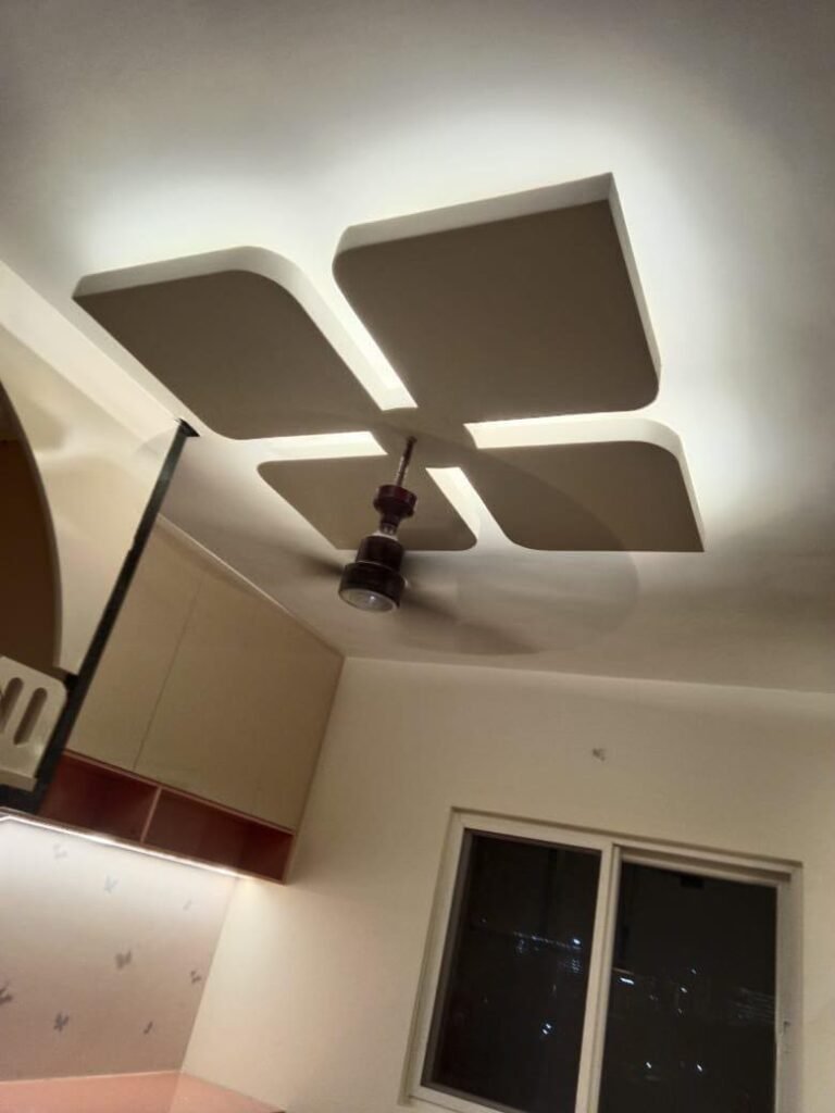 Designer false ceiling with cove lighting around the fan
