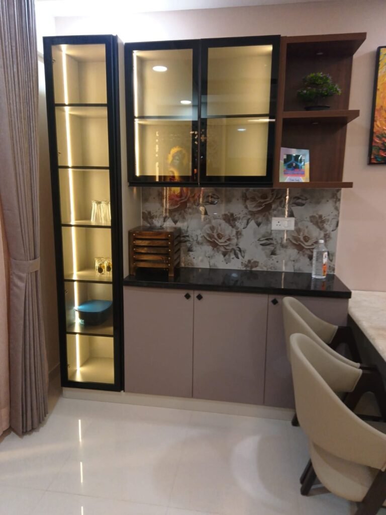 Crockery unit with lit glass shelves and a granite counter
