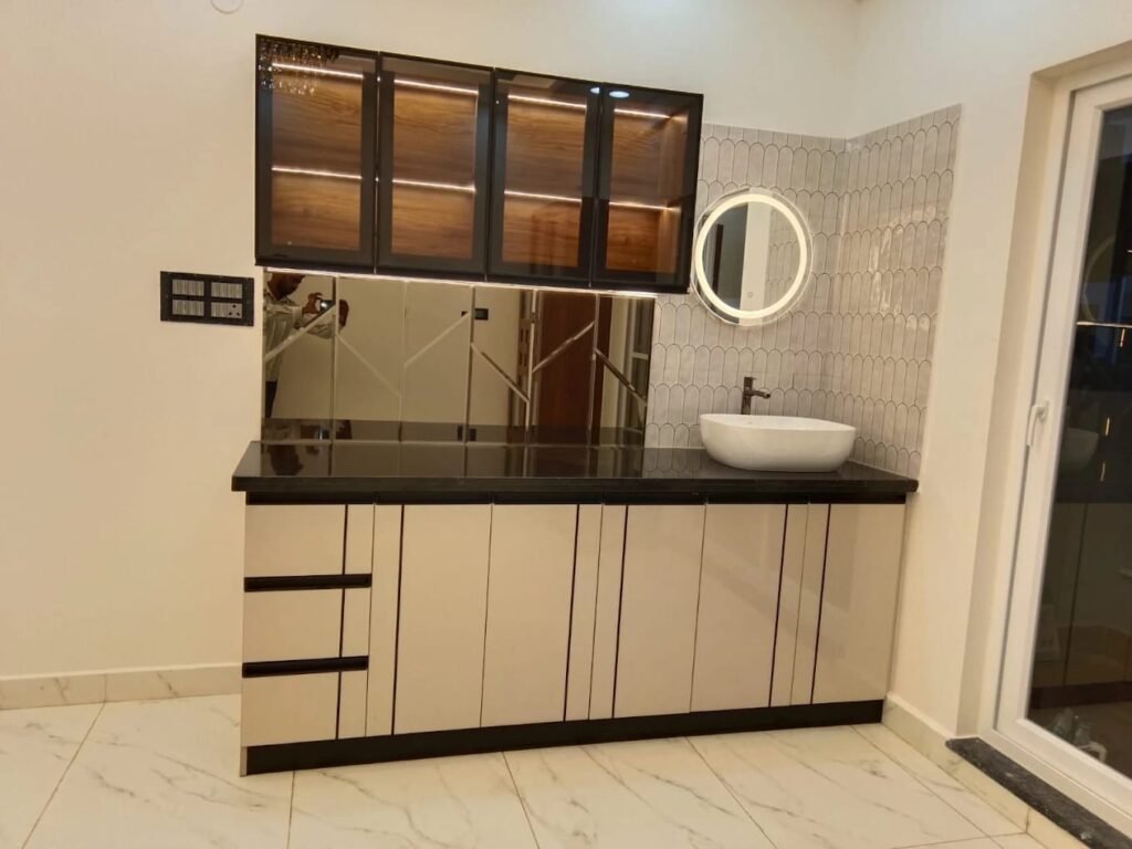 Wash basin vanity with a backlit mirror and glass-front cabinets